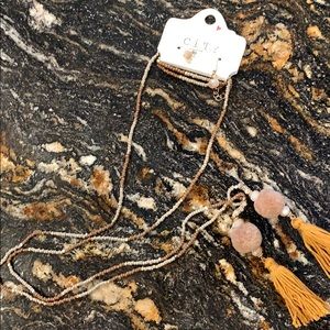 String style pompom necklace.